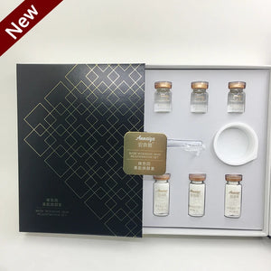 Set of glass vials and a white dish in a black and gold box with 'New' label.