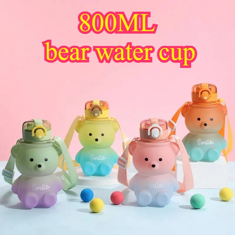 Colorful bear-shaped water cups with 'Smiles' text on a pink background