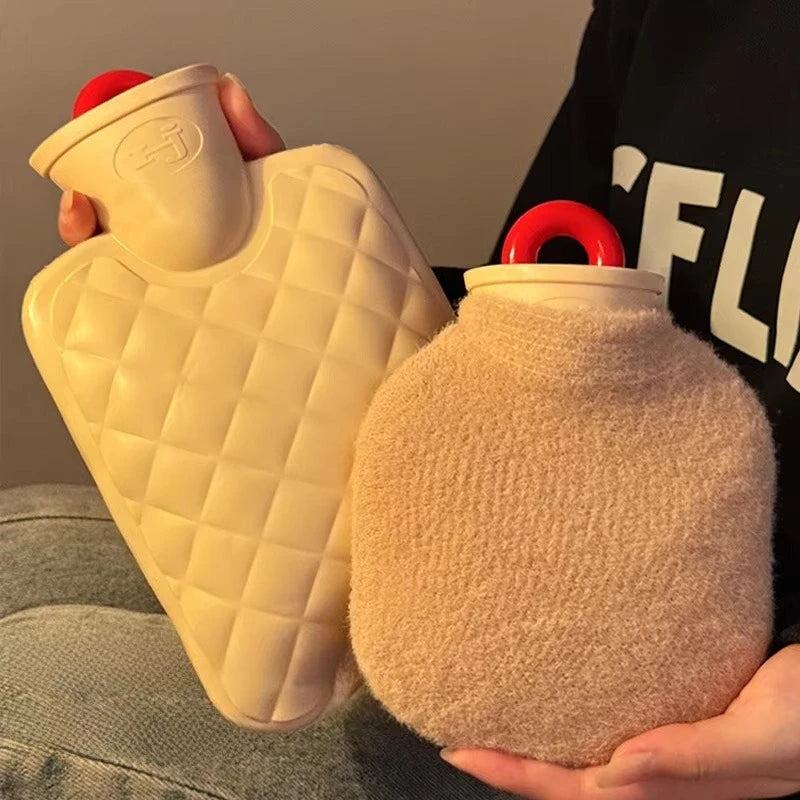 Two hot water bottles, one quilted and one fluffy, held by a person.