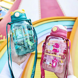 Two children's water bottles with colorful designs held against a bright, multicolored background.