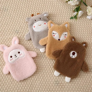 Four plush toys shaped like animals on a textured surface with flowers in the background.